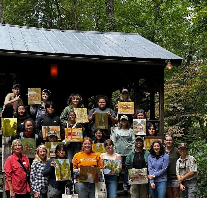 Fulton Student with finished paintings